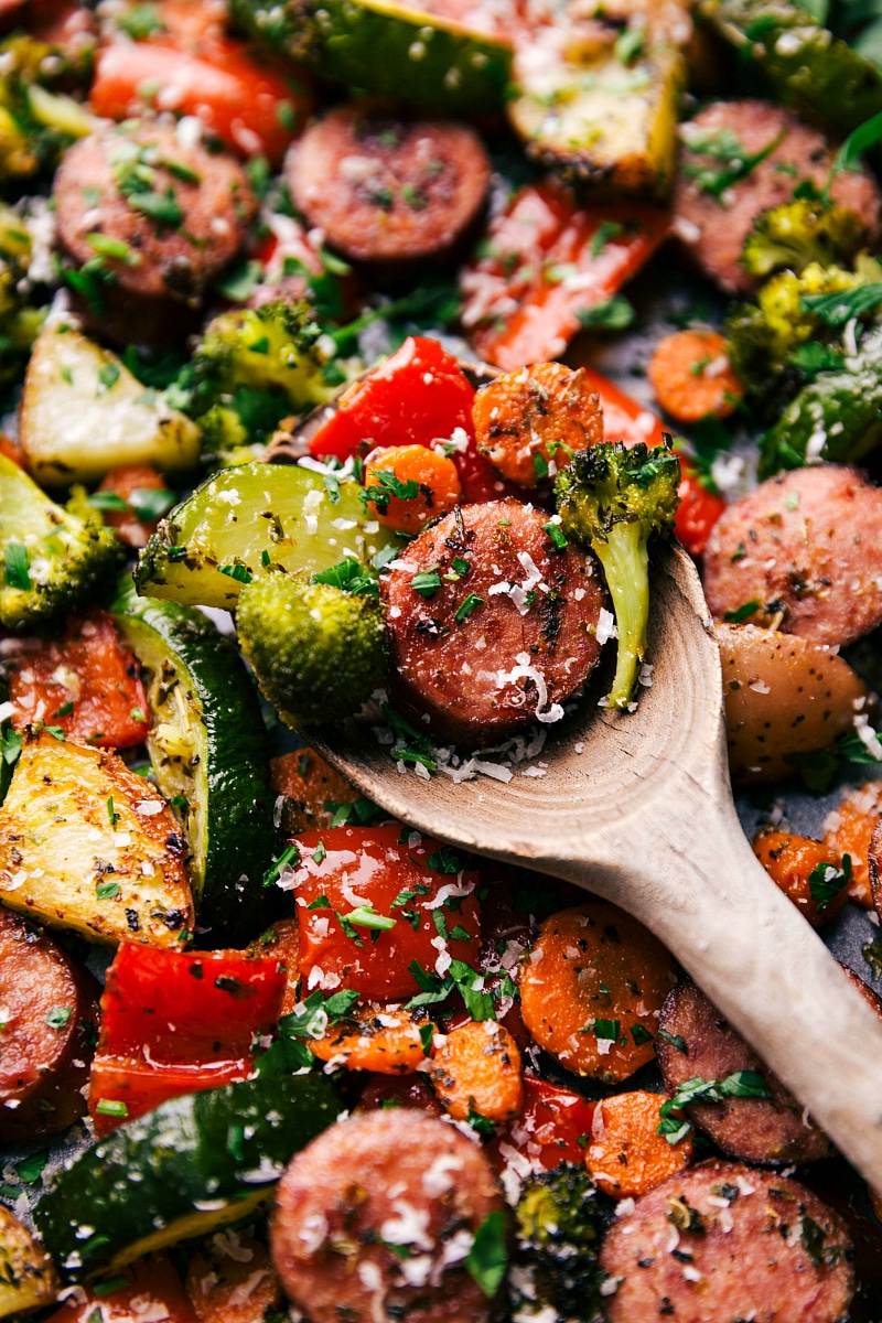 Image of a spoonful of the One-pan Italian Sausage and Veggies with a spoonful being picked up.