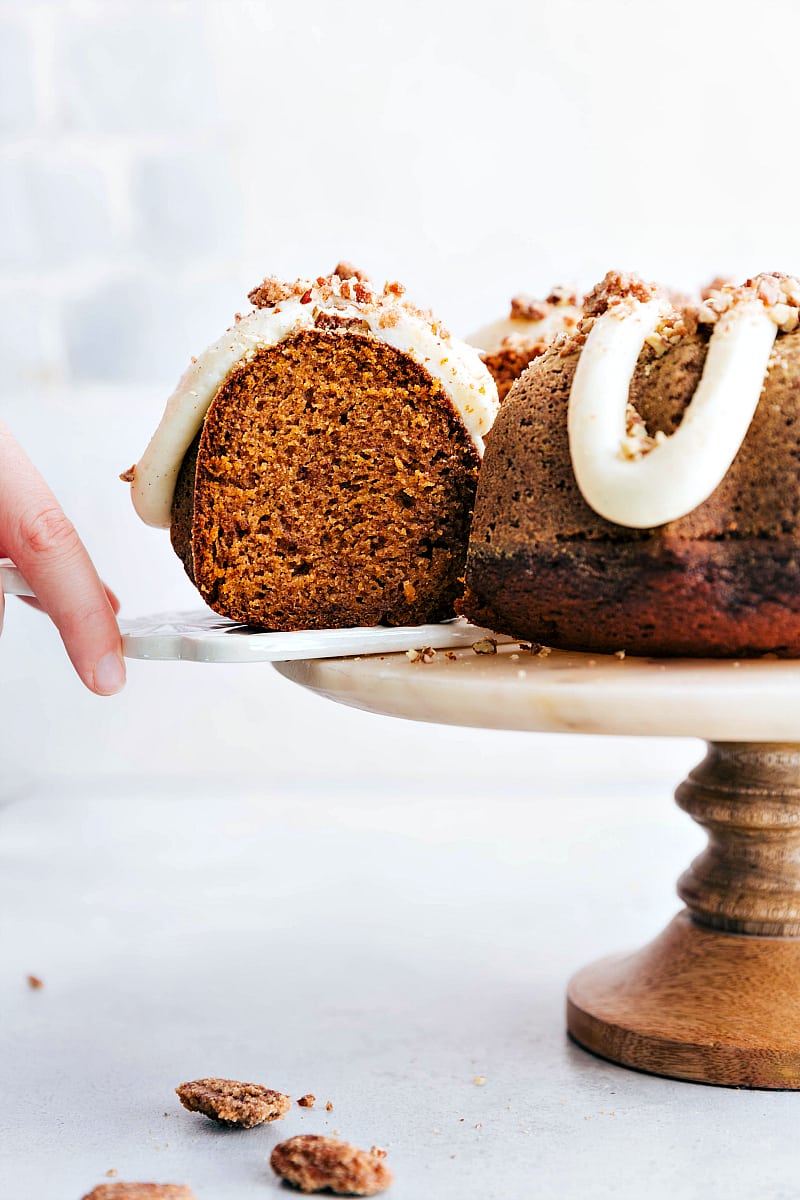 Image showing a hand removing a slice of Pumpkin Cake from the plate.